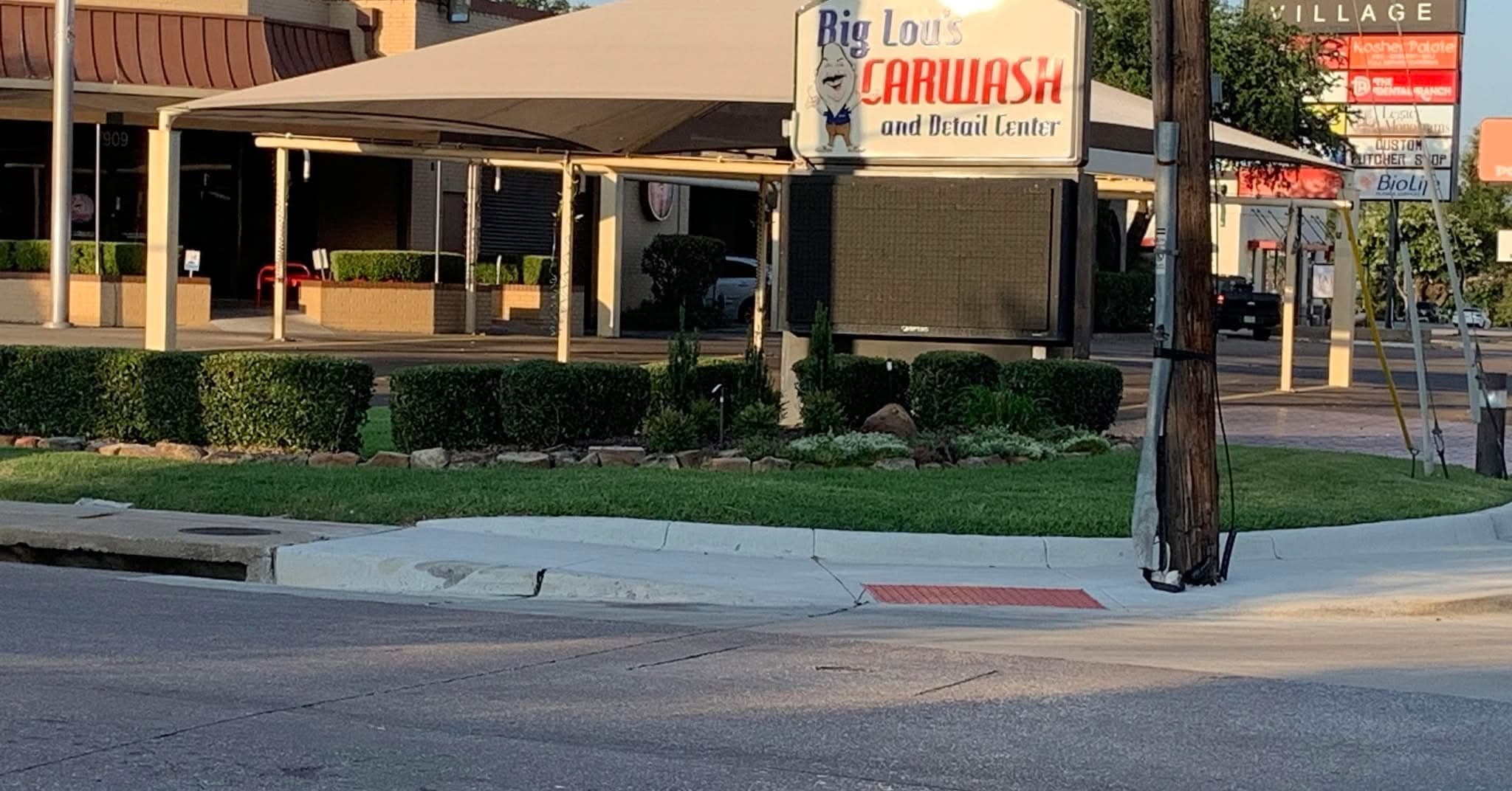 Big Lou's Car Wash and Detail Center on Belt Line Road in North Dallas, with covered wash bays and signage